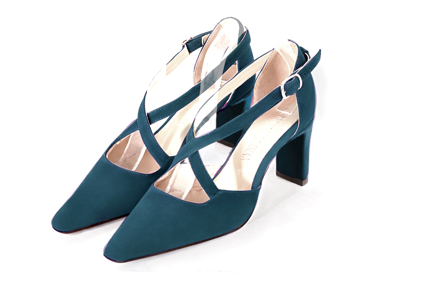 Peacock blue open side elegant shoes, with crossed straps. Tapered toe. High comma heels.